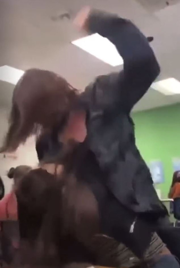 Horrific moment a female student punches another girl 30 times while others laugh and watch (video)