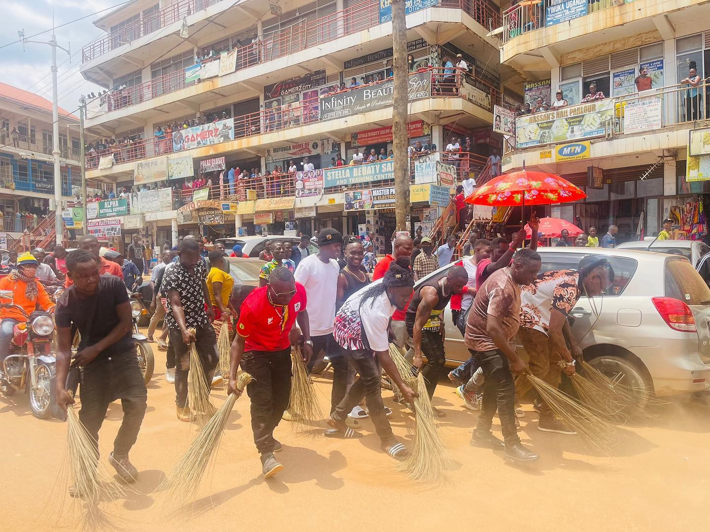 Popular Ugandan singer forced to sweep streets after turning up late for music show (photos/video) 