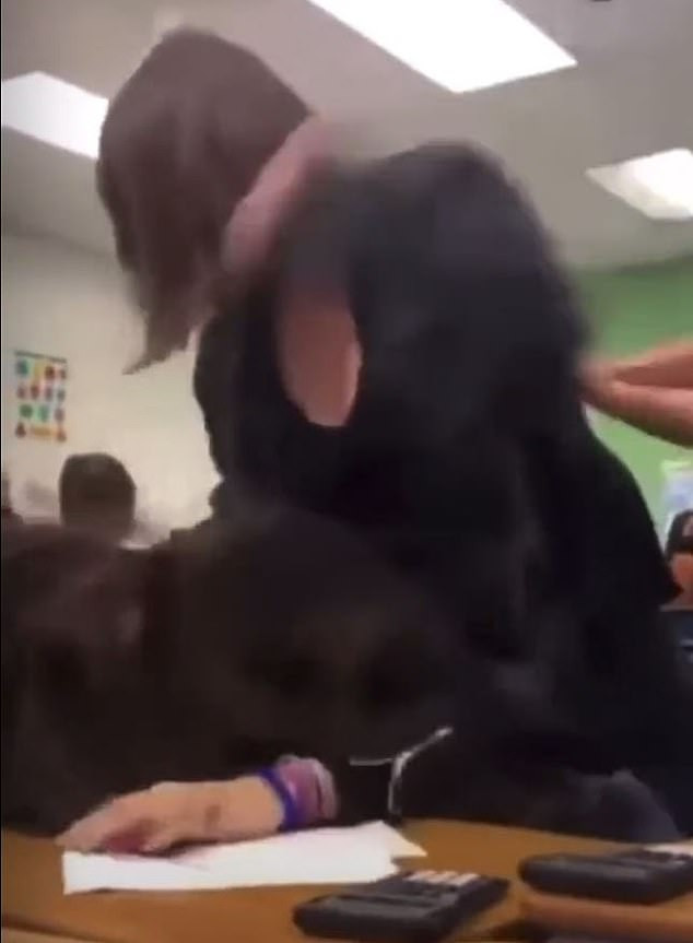 Horrific moment a female student punches another girl 30 times while others laugh and watch (video)