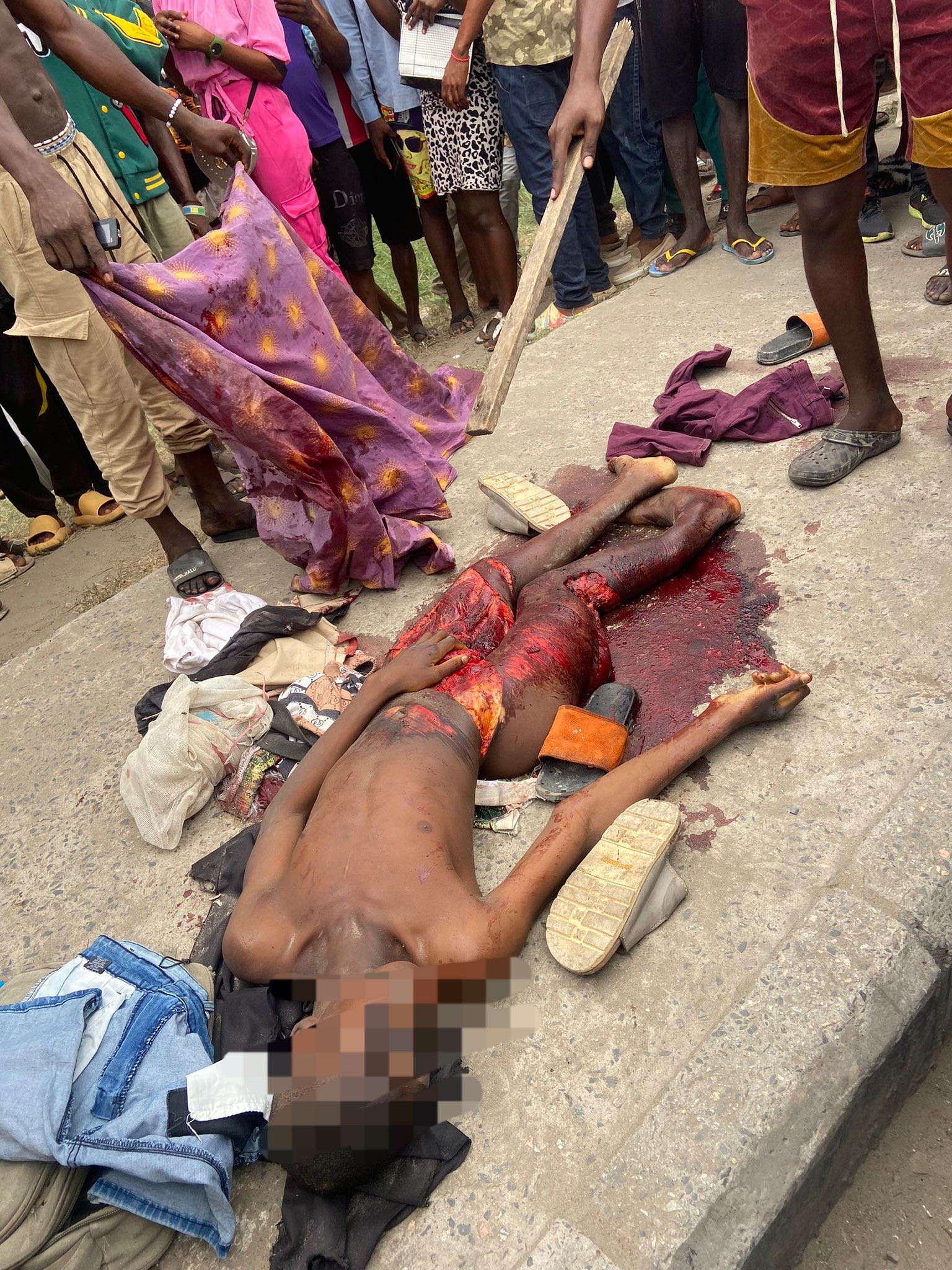 Chaos in Ajah as area boys go on rampage after a truck hit and killed two young men on a bike (graphic photos/videos)